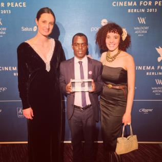 BERLIN: In February 2013 Call Me Kuchu and Ugandan activist group, Sexual Minorities Uganda (co-founded by David Kato) were both honored with the International Human Rights Film Award from the Cinema for Peace Foundation. Here we're grinning after receiving the award with Frank Mugisha, chairman of SMUG and one of the activists featured in the film.